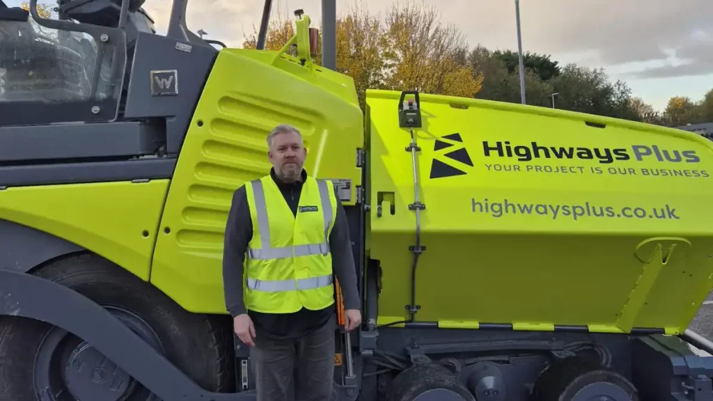 Tony Flook, Highways Plus stands next to the recently acquired VÖGELE SUPER 1803-3(i) wheeled paver 